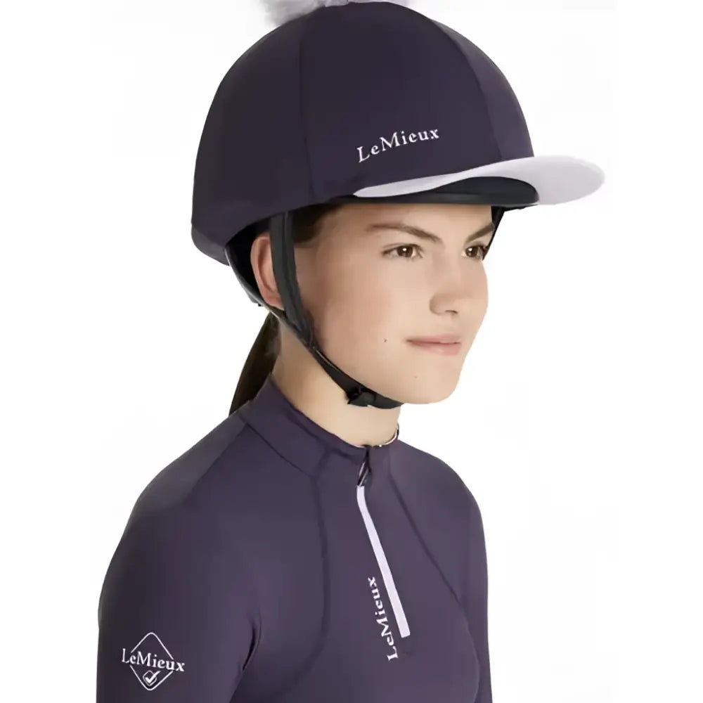 Navy blue lemieux classique pom equestrian helmet with white brim and embroidered silk juniper logo
