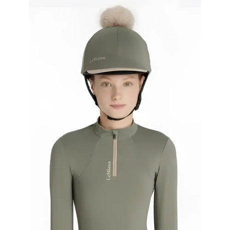 Olive green lemieux classique pom equestrian helmet with fluffy beige pom hat silk rosemary and white logo embroidery