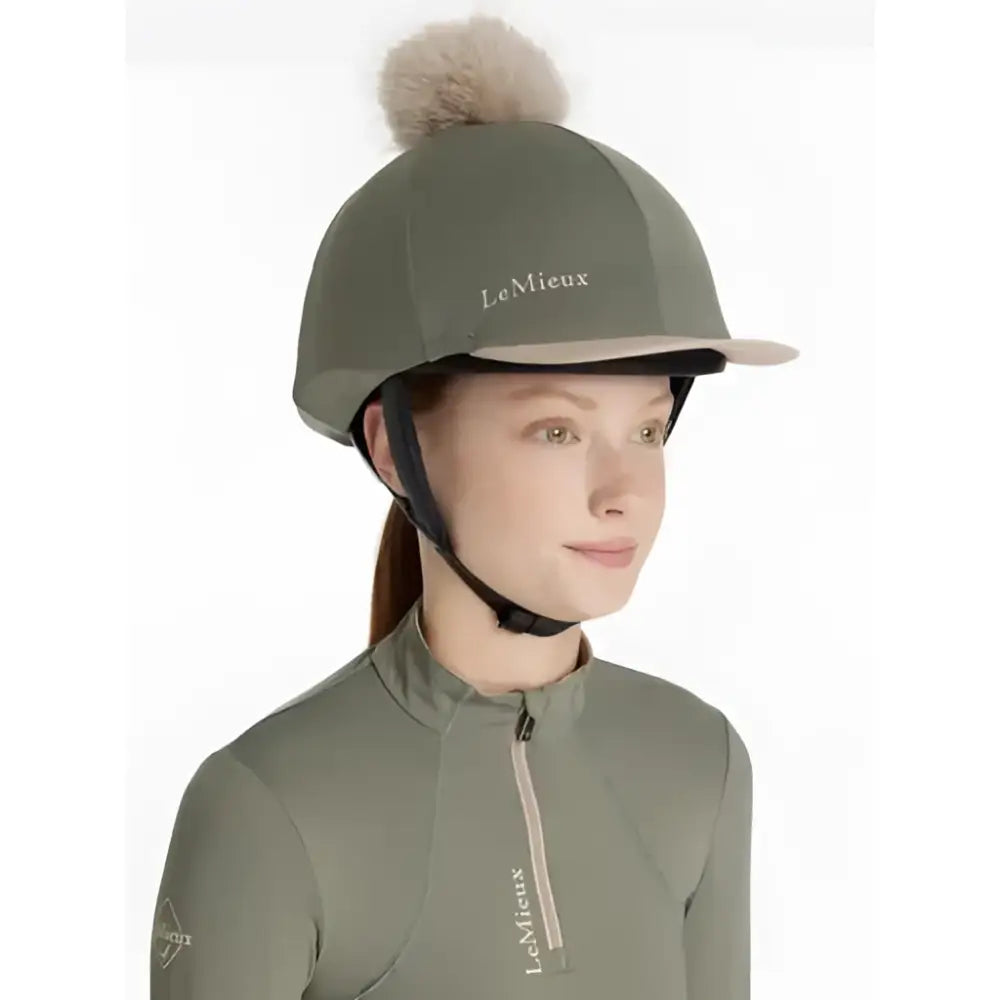 Olive green lemieux classique pom equestrian helmet with fluffy beige pom hat silk rosemary and white logo embroidered