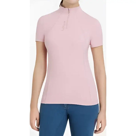 A soft pink lemieux classique short sleeve polo with half-zip collar and subtle blossom base layer logo on left chest