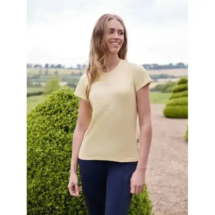 A soft pale yellow lemieux classique t-shirt with short sleeves and a subtle embroidered heart perfect for equestrian style