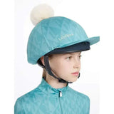 Teal geometric-patterned lemieux clea hat silk lagoon cover with cream pom-pom for equestrian helmets