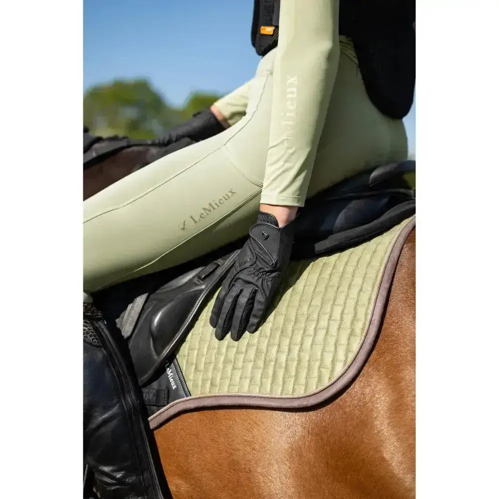 Front view of lemieux close contact black leather riding glove with subtle logo and innovative technical fabric