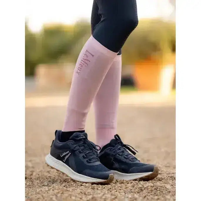 Pink lamotte compression sleeves worn over black leggings featuring lemieux competition socks 2 pack blossom design
