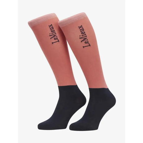 A pair of coral and black two-tone lemieux competition socks with elegant black script logo on the upper leg