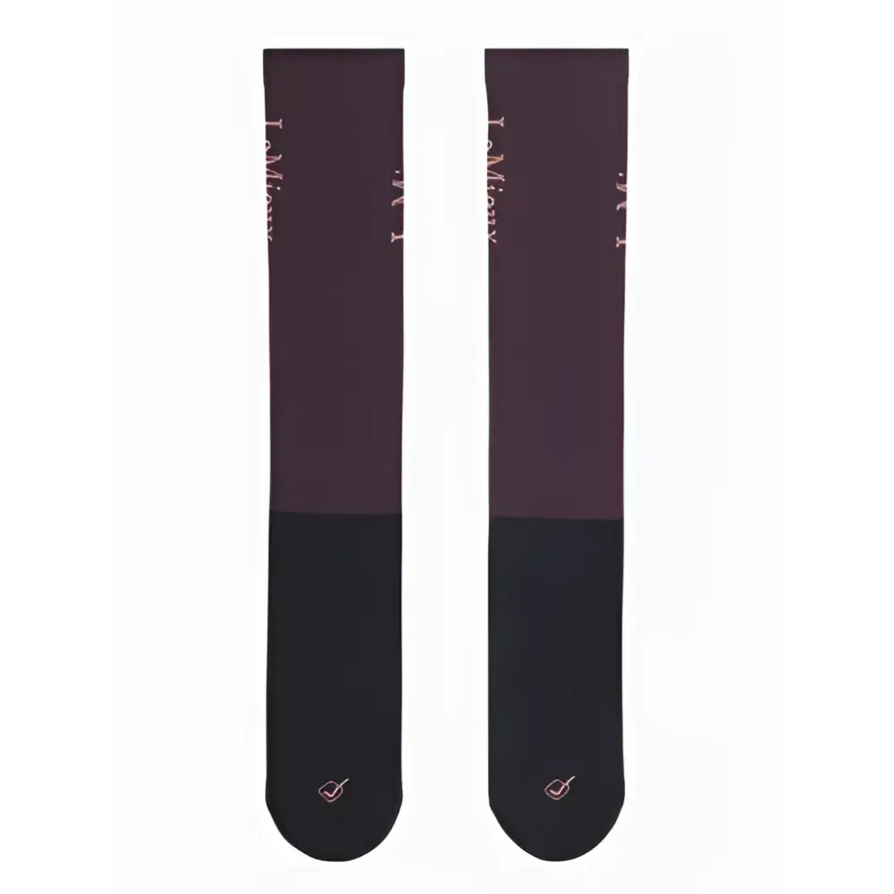 A pair of lemieux competition socks in dark purple and black with a subtle pink logo at the toe for competition use