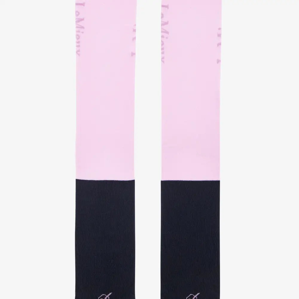 A pair of pink and black two-tone lemieux competition socks with a subtle brand logo near the top in fondant color