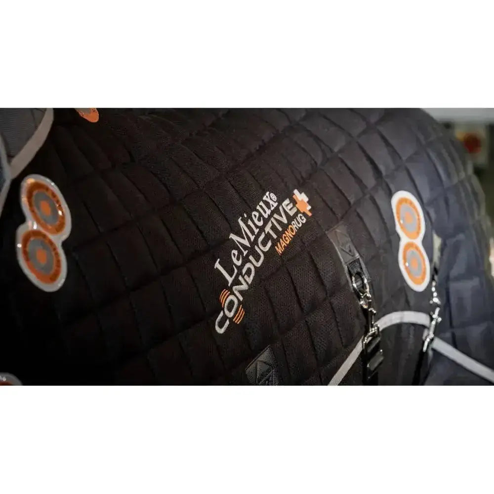 Black quilted lemieux conductive magno rug with orange white branding and gauss twin magnets for horses