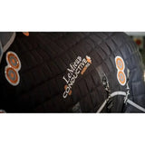 Black quilted lemieux conductive magno rug with orange white branding and gauss twin magnets for horses