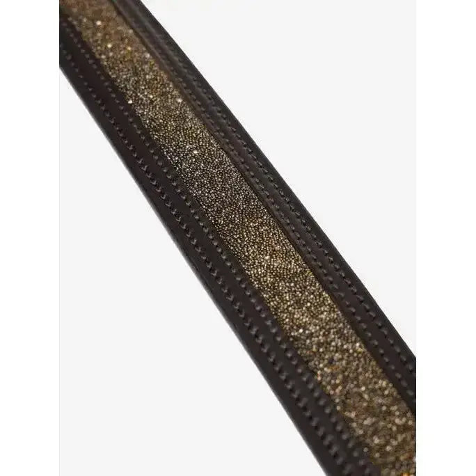 A sleek black leather lemieux crystal insert belt with a shimmering gold tonal crystal panel and precise stitching