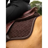 Brown quilted lemieux crystal suede close saddle pad with plush fleece edge and stitched border for forward-cut jumping saddles
