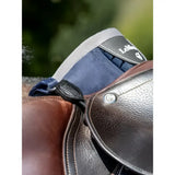 Brown leather saddle with navy blue padded flap and black stitching showing lemieux d-ring extender for adding extra room