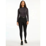 Black long-sleeved high-neck athletic top with subtle gradient finish paired with lemieux demi pull breggings black full-seat silicone grip