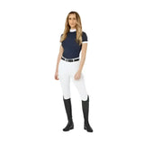 Navy blue lemieux demi pull short-sleeved equestrian top with white trim and high collar paired with breggings white full-seat silicone grip