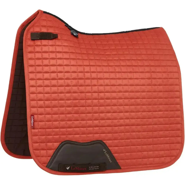 Red quilted lemieux dressage suede saddle pad with black soft suede binding and branded label in suede square sienna style
