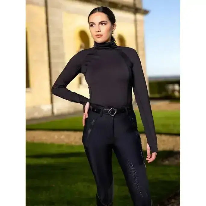Black long-sleeved turtleneck top with subtle side panels paired with lemieux drytex waterproof breeches for all-weather riding
