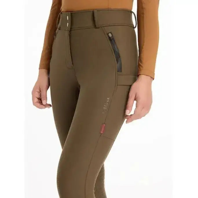 Olive green lemieux drytex waterproof breeches with high waist zippered pockets and knee grip alpine branding on thigh