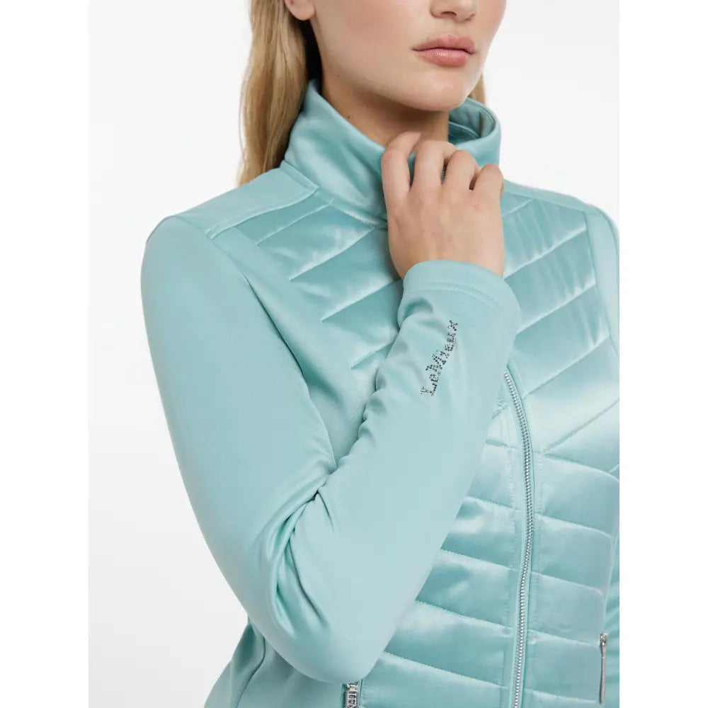 Light blue quilted lemieux dynamique jacket aqua with high collar and subtle brand embroidery on the sleeve