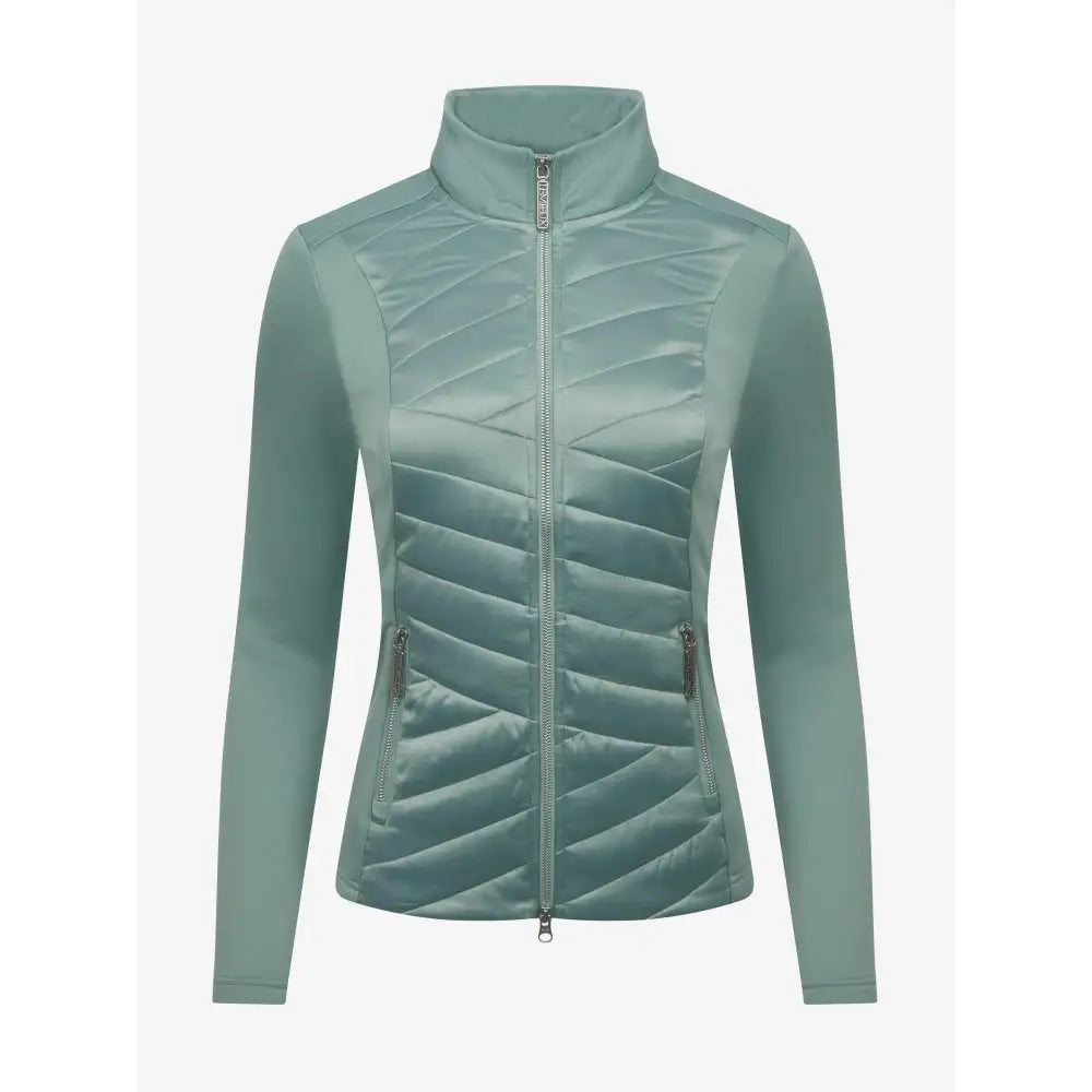 A sleek light teal quilted lemieux dynamique jacket with high collar and zippered side pockets for cold weather