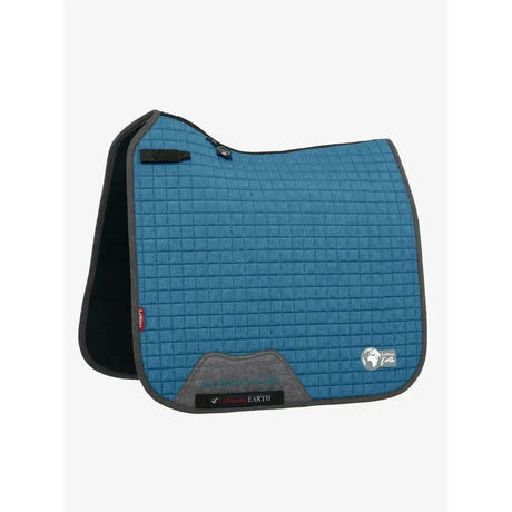 Blue quilted lemieux earth dressage saddle pad with black and gray trim and branded earth dressage square label
