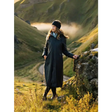 Woman in a Lemieux Elements Coat Navy and beanie standing on a scenic hillside