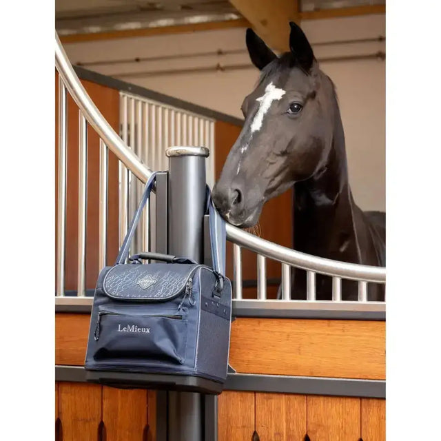 Navy blue lemieux elite pro grooming bag with silver embroidery and front zippered pocket for grooming essentials