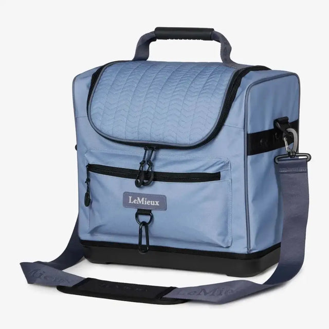 Light blue quilted lemieux elite pro grooming bag powder blue with black trim and adjustable shoulder strap for grooming essentials