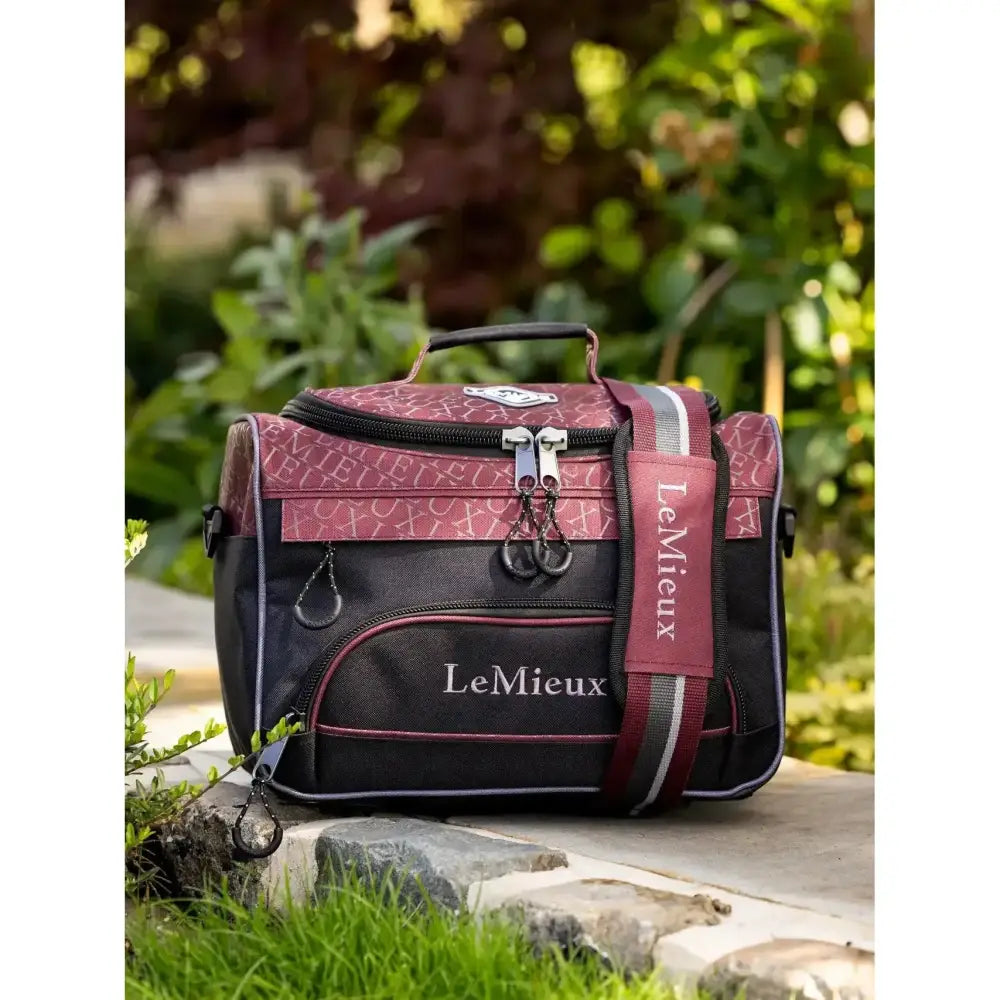 Maroon and black lemieux elite prokit lite grooming bag burgundy with repeating pattern silver zippers and branded strap