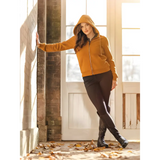 Woman in a mustard yellow Lemieux Elle Zip Through Hoodie Ginger and dark pants