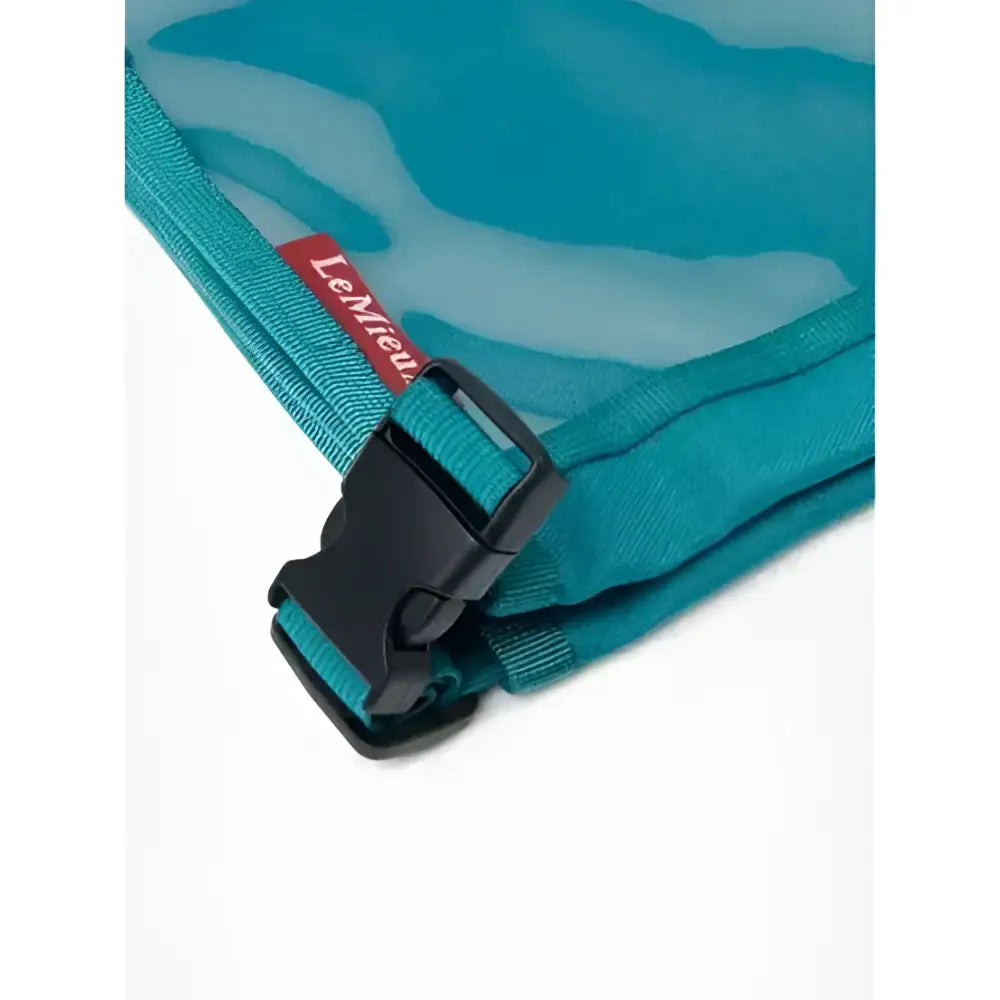 Teal mesh travel bag with black buckle and red le mieux tag for lemieux eventing bib peacock gear storage