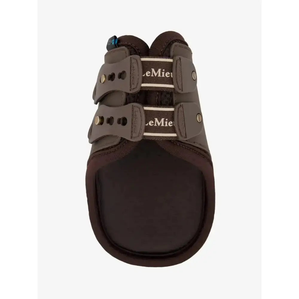 Dark brown leather lemieux exo-flex® fetlock boot with two adjustable straps and white branding for performance horses