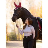 Black horse with red ear bonnet and bridle wearing Lemieux Faith Base Layer Ash