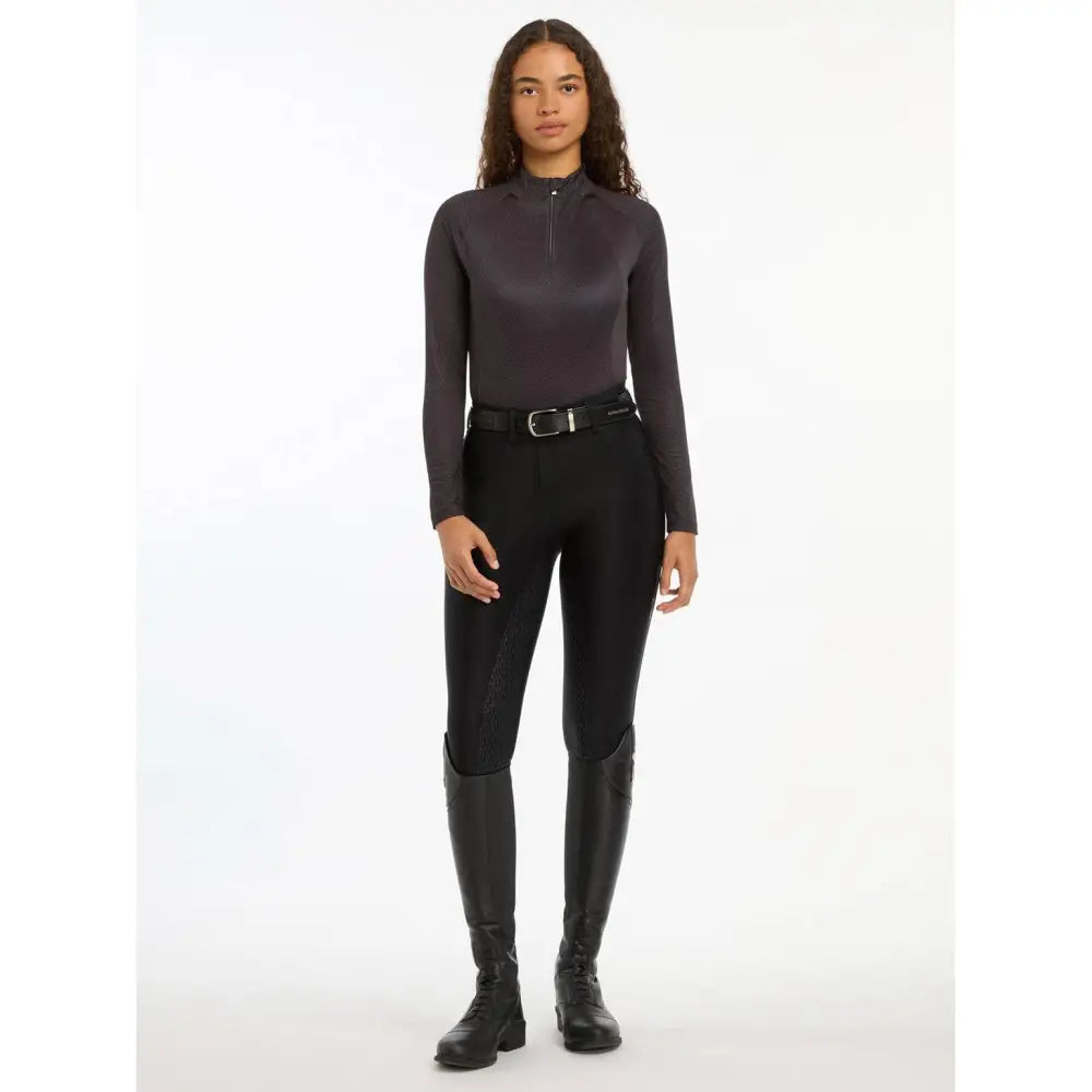 Woman in dark gray turtleneck and black pants showcasing Lemieux Faith Base Layer Cinder