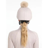 A soft light gray lemieux faith hat with a fluffy beige pom-pom made from faith hat silk material