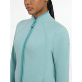 A light blue lemieux faye fleece zip soft shell jacket with a subtle logo on the sleeve for cozy wear