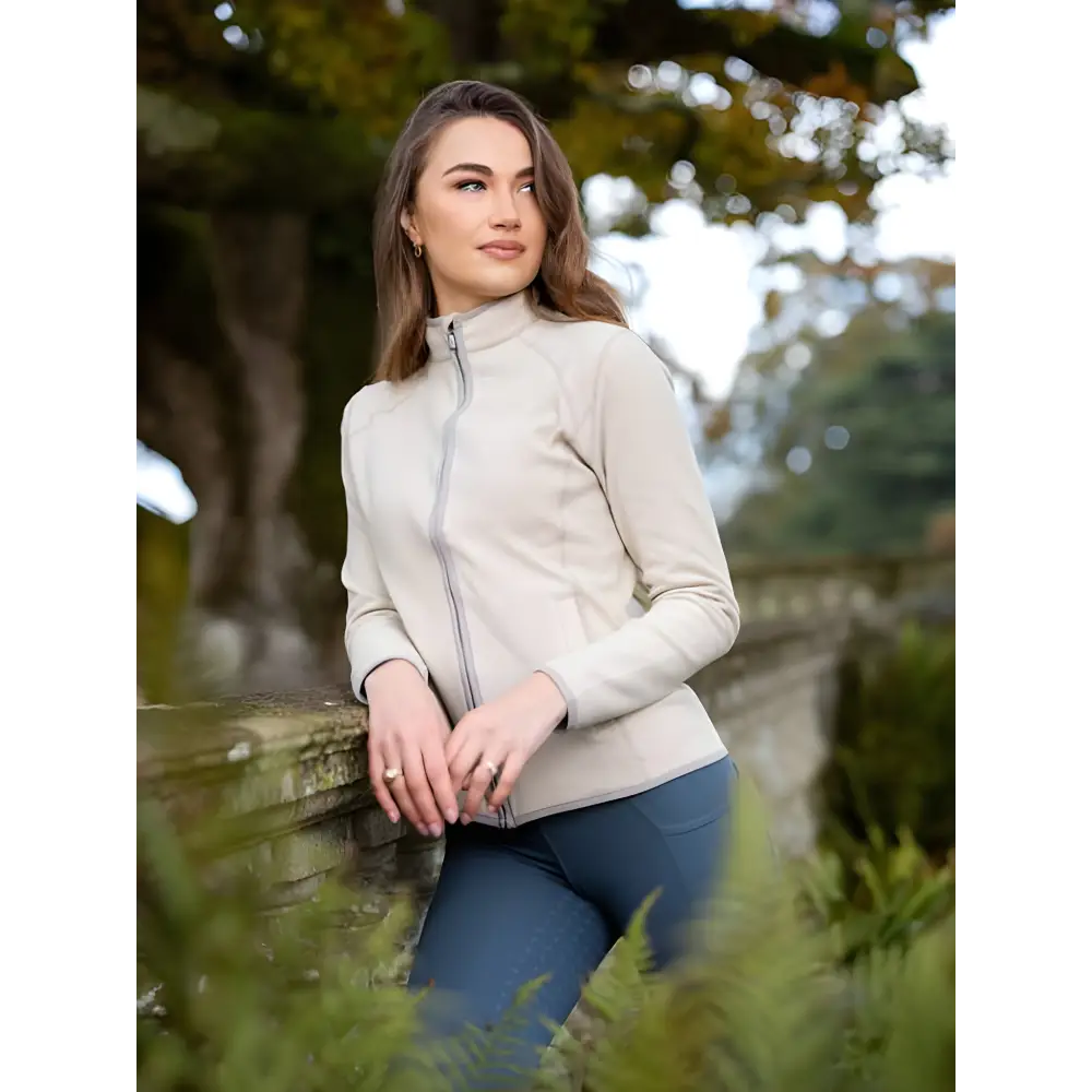 Young woman in Lemieux Faye Fleece Zip Through Stone with cream zip-up sweater