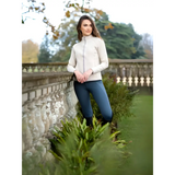 Young woman in Lemieux Faye Fleece Zip Through Stone next to ornate balustrade