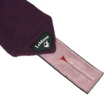 A plush deep purple lemieux fig classic scarf with soft textured fabric and a luxury lemieux fleece branded tag