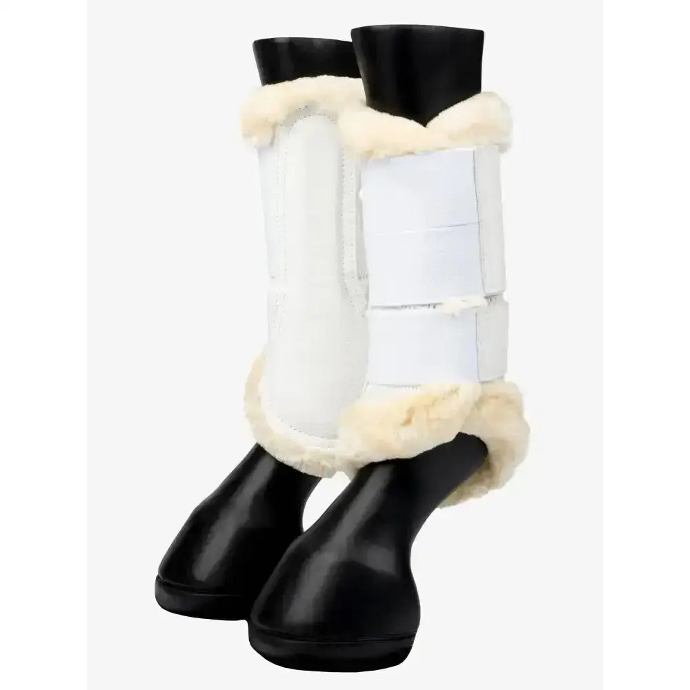 White lemieux fleece edged mesh brushing boot with cream fleece trim and black rubber soles for horse protection
