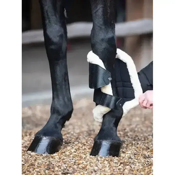 Black leather lemieux fleece edged mesh brushing boots with cozy white fleece lining for horse leg protection