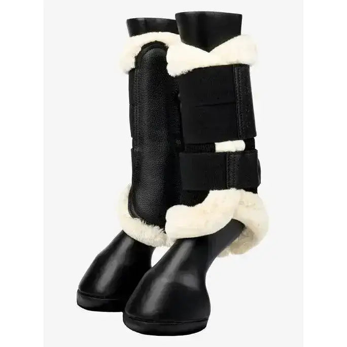 Black leather lemieux fleece edged mesh brushing boots with white shearling trim and adjustable velcro straps