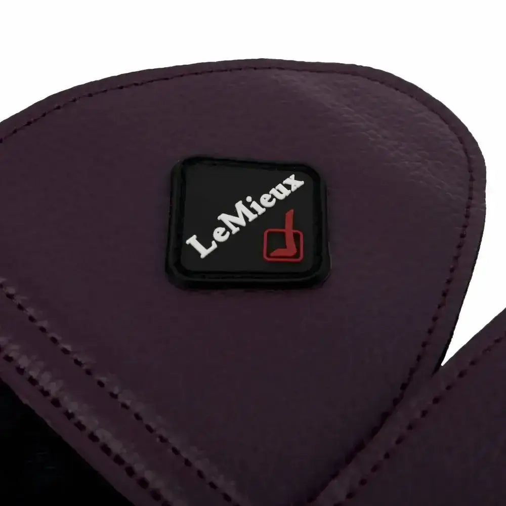 Dark purple leather lemieux fleece lined brushing boots fig with black patch featuring lemieux logo and red emblem