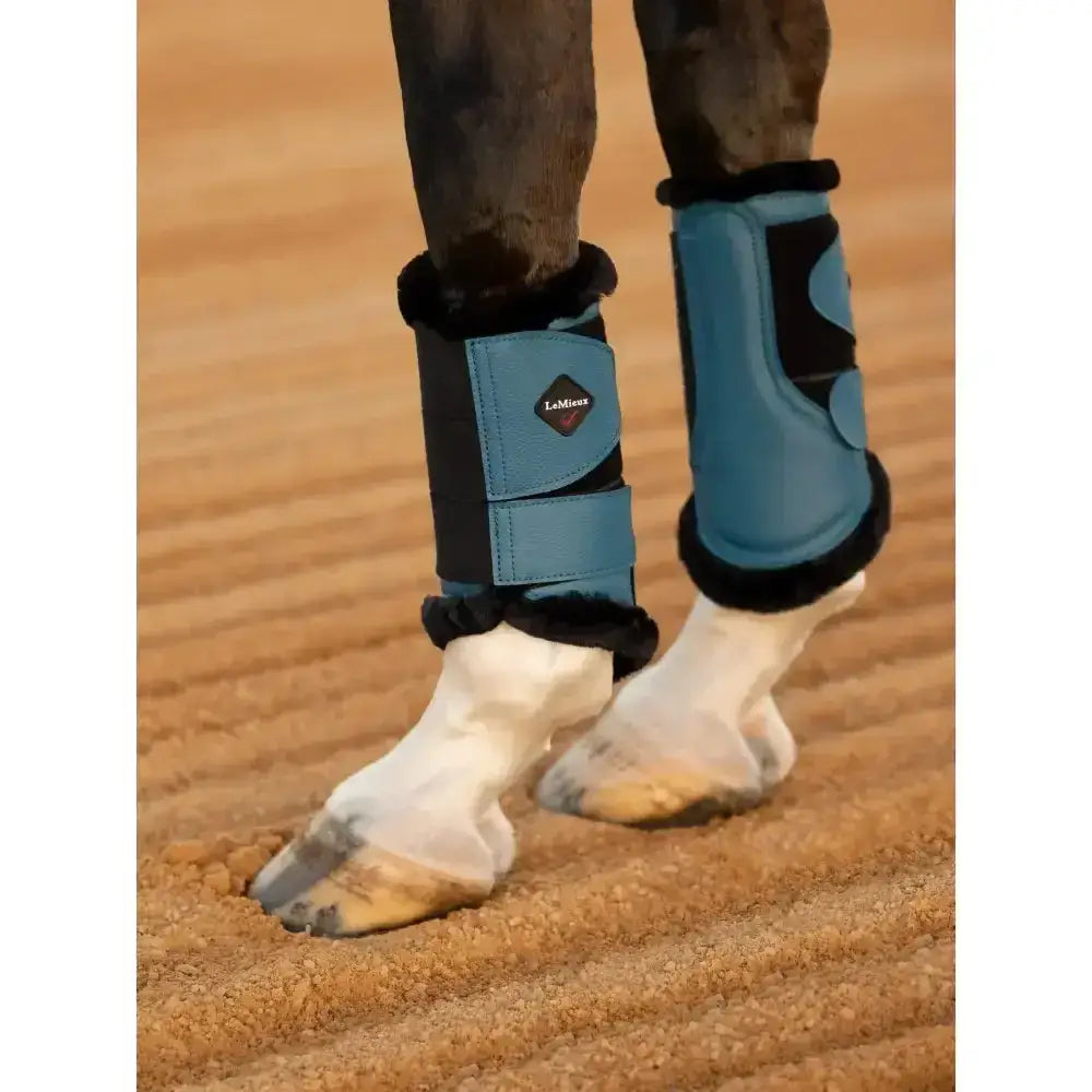 Blue and black lemieux fleece lined brushing boots with plush trim in marine beautifully fitting design