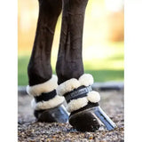 White fleece-lined lemieux fleece pastern wrap with black strap featuring lightweight lemieux fleece material