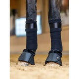 Black leather lemieux fleece wrapround overreach boots with plush fleece lining and adjustable straps for protection