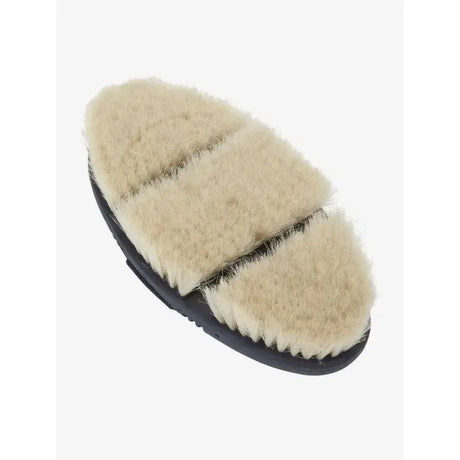 Cream-colored sheepskin covered lemieux flexi goat hair body brush with black rubber base for gentle grooming