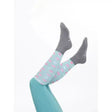 Light blue lemieux footsie socks flying pigs with playful pink flamingo pattern paired with dark gray lambs & ivy socks