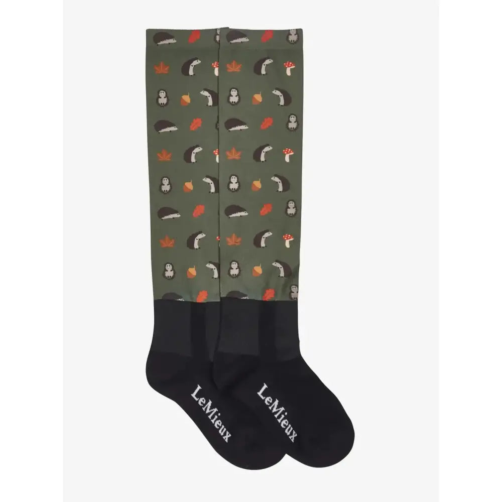 Olive green lemieux footsie socks with playful hedgehogs crowns mushrooms and acorns pattern in black white red and orange