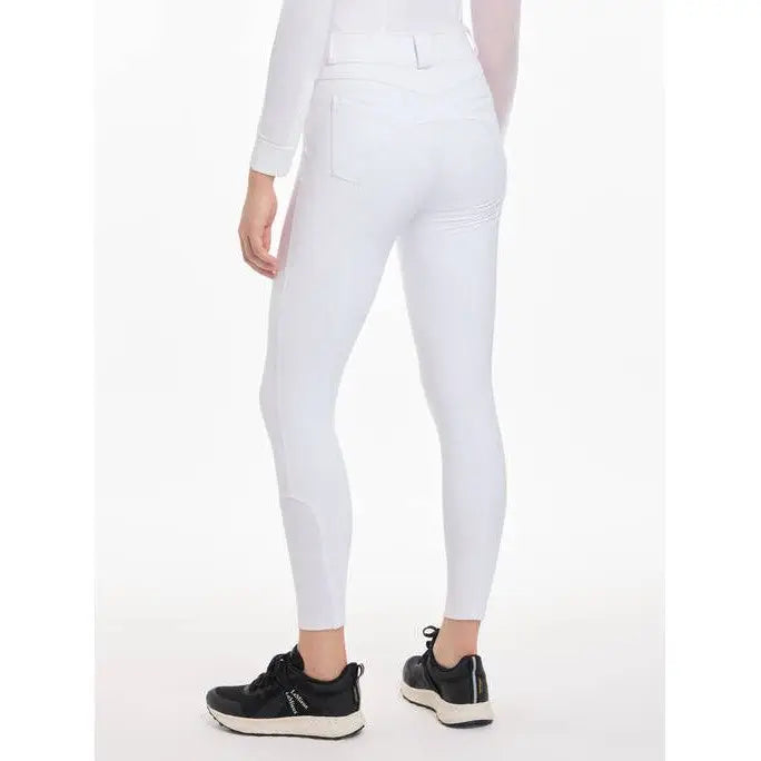 White Lemieux Freya Pro Breeches worn with black sneakers, crafted from highly durable fabric