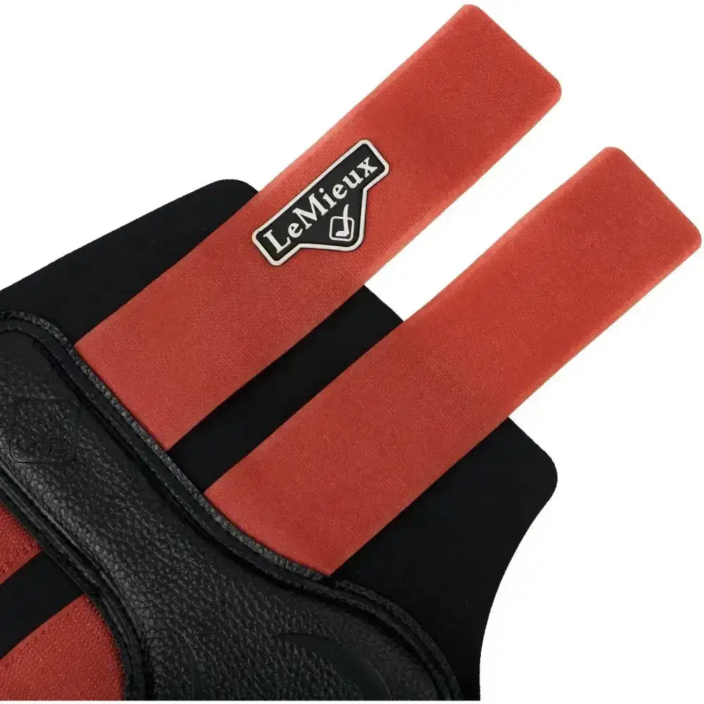 Red and black leather horse riding glove with lemieux logo patch paired with lemieux grafter boot sienna hard working boot